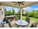 Covered patio with ceiling fan, table with chairs, grill and hot tub at 916 Settlers Walk, Brownsburg, IN 46112
