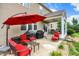 Cozy outdoor patio area with red umbrella, grilling area and comfortable seating at 916 Settlers Walk, Brownsburg, IN 46112