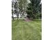 Spacious backyard featuring a shed nestled among mature trees and a well-manicured lawn at 9467 N Michigan Rd, Fairland, IN 46126
