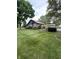 Inviting brown home featuring lush green lawn and mature trees on a cloudy day at 9467 N Michigan Rd, Fairland, IN 46126