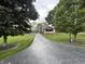 View of the home from the long driveway and showing the detached garage at 9467 N Michigan Rd, Fairland, IN 46126