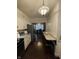 Galley kitchen with breakfast bar featuring stainless appliances, white cabinets and hardwood floors at 9467 N Michigan Rd, Fairland, IN 46126