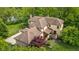 Aerial view of the home with tile roof showcasing the lush landscaping at 9601 Irishmans Run Ln, Zionsville, IN 46077