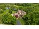 Picturesque aerial view of the home and its beautifully landscaped surroundings including a pond at 9601 Irishmans Run Ln, Zionsville, IN 46077