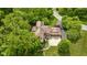 Aerial view of the home with mature trees and 3-car garage at 9601 Irishmans Run Ln, Zionsville, IN 46077
