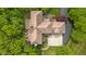Aerial view of the house showing the tile roof, patio, and expansive driveway at 9601 Irishmans Run Ln, Zionsville, IN 46077