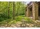 A portion of a stone patio beneath a deck on a property with a luscious tree line at 9601 Irishmans Run Ln, Zionsville, IN 46077