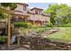 Backyard landscape including terraced stone planters and a view of the attached three-car garage at 9601 Irishmans Run Ln, Zionsville, IN 46077