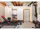 Basement gym area featuring workout equipment, white storage cabinet, and concrete flooring at 9601 Irishmans Run Ln, Zionsville, IN 46077