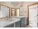 Bright bathroom featuring double sinks with marble countertops, light blue cabinetry, and access to a shower/tub combo at 9601 Irishmans Run Ln, Zionsville, IN 46077