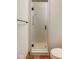 Modern bathroom with a textured glass shower door and tile accents at 9601 Irishmans Run Ln, Zionsville, IN 46077