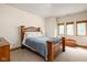 Bedroom with a wooden bed frame, neutral-toned walls, and a large window with natural light at 9601 Irishmans Run Ln, Zionsville, IN 46077