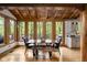 Inviting dining area features a solid wood table and chairs with views to a wooden deck at 9601 Irishmans Run Ln, Zionsville, IN 46077
