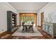 Dining room showcases a rustic table set with a view into a sunroom at 9601 Irishmans Run Ln, Zionsville, IN 46077
