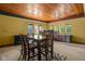Spacious dining room featuring a wood ceiling, table, chairs, and windows with natural light at 9601 Irishmans Run Ln, Zionsville, IN 46077