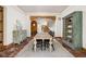 Dining room showcases a rustic table set near stairs and entry to the home at 9601 Irishmans Run Ln, Zionsville, IN 46077