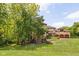 A back exterior view of a home featuring a luscious yard and an attached three-car garage at 9601 Irishmans Run Ln, Zionsville, IN 46077