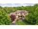 Majestic home featuring a brown tile roof surrounded by lush greenery at 9601 Irishmans Run Ln, Zionsville, IN 46077