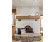 Stone fireplace with wooden mantle in living room with stone base at 9601 Irishmans Run Ln, Zionsville, IN 46077