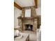 Stone fireplace with a wood mantel adds warmth to the inviting living space at 9601 Irishmans Run Ln, Zionsville, IN 46077