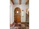 Elegant foyer with an arched wooden door, stained glass window, and staircase at 9601 Irishmans Run Ln, Zionsville, IN 46077