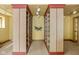 Hallway featuring two walls of built-in shelves, neutral carpet, a decorative wreath, and recessed lighting at 9601 Irishmans Run Ln, Zionsville, IN 46077