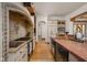 Well-equipped kitchen featuring wooden beams, tile countertops, and custom cabinetry enhancing this living space at 9601 Irishmans Run Ln, Zionsville, IN 46077