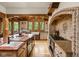 Spacious kitchen boasts wooden beams, center island, and ample counter space and natural light from multiple windows at 9601 Irishmans Run Ln, Zionsville, IN 46077