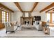 Cozy living room featuring a stone fireplace, neutral decor, and plenty of seating for relaxation and entertainment at 9601 Irishmans Run Ln, Zionsville, IN 46077