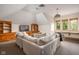 Bright living room with vaulted ceilings, large windows, and built-in wooden shelving surrounding the television at 9601 Irishmans Run Ln, Zionsville, IN 46077