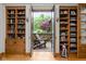 Charming living area with bookshelves, leading to an outdoor patio at 9601 Irishmans Run Ln, Zionsville, IN 46077