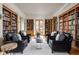 The living room is flanked by built-in bookshelves and plenty of seating at 9601 Irishmans Run Ln, Zionsville, IN 46077