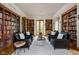 Spacious living room with custom bookshelves and cozy seating arrangement at 9601 Irishmans Run Ln, Zionsville, IN 46077