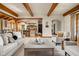 Inviting living room with exposed wood beams and an open floor plan to the kitchen at 9601 Irishmans Run Ln, Zionsville, IN 46077