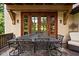 Covered outdoor dining area featuring a wrought iron table and seating for eight at 9601 Irishmans Run Ln, Zionsville, IN 46077