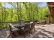 Covered patio area with an outdoor dining space with views of the tree line in the background at 9601 Irishmans Run Ln, Zionsville, IN 46077