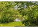 Scenic view of the tranquil pond surrounded by lush greenery and mature trees at 9601 Irishmans Run Ln, Zionsville, IN 46077
