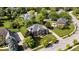 Beautiful brick home with manicured lawn, mature trees, and a paved driveway in a quiet neighborhood at 9973 Woods Edge Dr, Fishers, IN 46037
