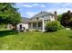 Large grassy backyard with patio and screened-in porch at 9973 Woods Edge Dr, Fishers, IN 46037