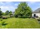 Spacious backyard with green lawn, patio, and firepit at 9973 Woods Edge Dr, Fishers, IN 46037