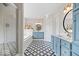 Stylish bathroom with blue cabinetry, soaking tub, glass shower, and dual vanity at 9973 Woods Edge Dr, Fishers, IN 46037
