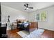 Cozy bedroom with hardwood floors, a wooden bed frame, and a large window at 9973 Woods Edge Dr, Fishers, IN 46037