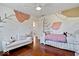 Stylish bedroom featuring modern wall art, hardwood floors, and a comfortable seating area at 9973 Woods Edge Dr, Fishers, IN 46037