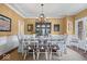 Traditional dining room with hardwood floors, natural light, and seating for eight at 9973 Woods Edge Dr, Fishers, IN 46037