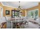 Traditional dining room features elegant chandelier, wainscoting and furniture at 9973 Woods Edge Dr, Fishers, IN 46037