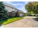 Exterior side view of a brick home with a basketball court and three-car garage at 9973 Woods Edge Dr, Fishers, IN 46037