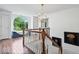 Bright hallway features hardwood floors, window seat, and decorative lighting at 9973 Woods Edge Dr, Fishers, IN 46037
