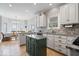 Well-lit kitchen with granite countertops, white cabinetry, and eat-in dining area at 9973 Woods Edge Dr, Fishers, IN 46037