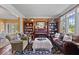 Cozy living room features built-in bookshelves, a leather couch and lots of light at 9973 Woods Edge Dr, Fishers, IN 46037