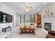 Comfortable living room with fireplace, neutral carpet, and natural light at 9973 Woods Edge Dr, Fishers, IN 46037